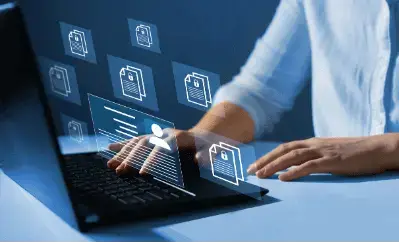 Bookkeeper on SAP HANA 8 Person using a laptop with digital document icons projecting from the screen, symbolizing file management.
