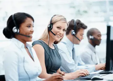 Call center employees with headsets working at computers.